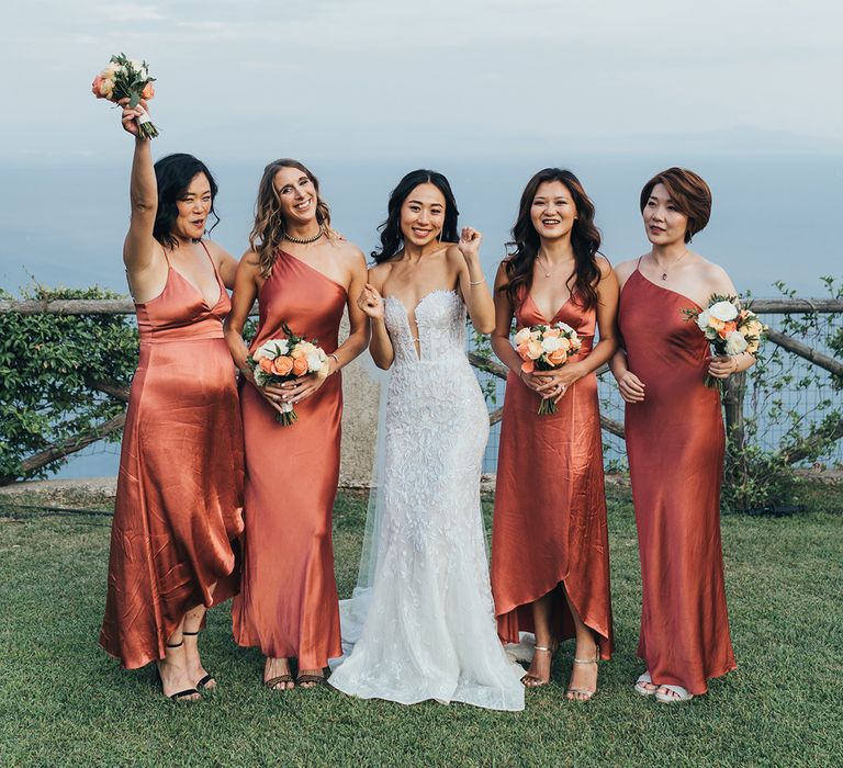 Bridal party portrait with the bridesmaids in coral dresses 