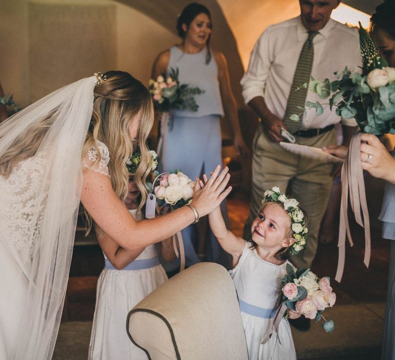 The bride high fives her flower girl