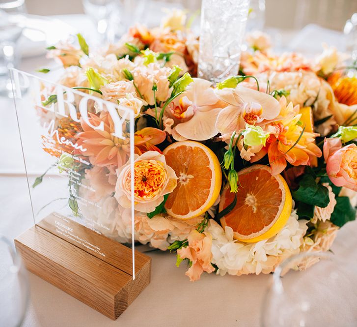 Citrus centerpiece with peach floral bouquet for barn wedding