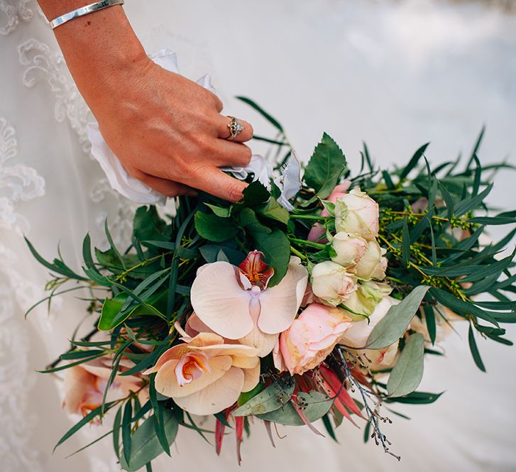 Bride holding wedding bouquet with peach wedding theme