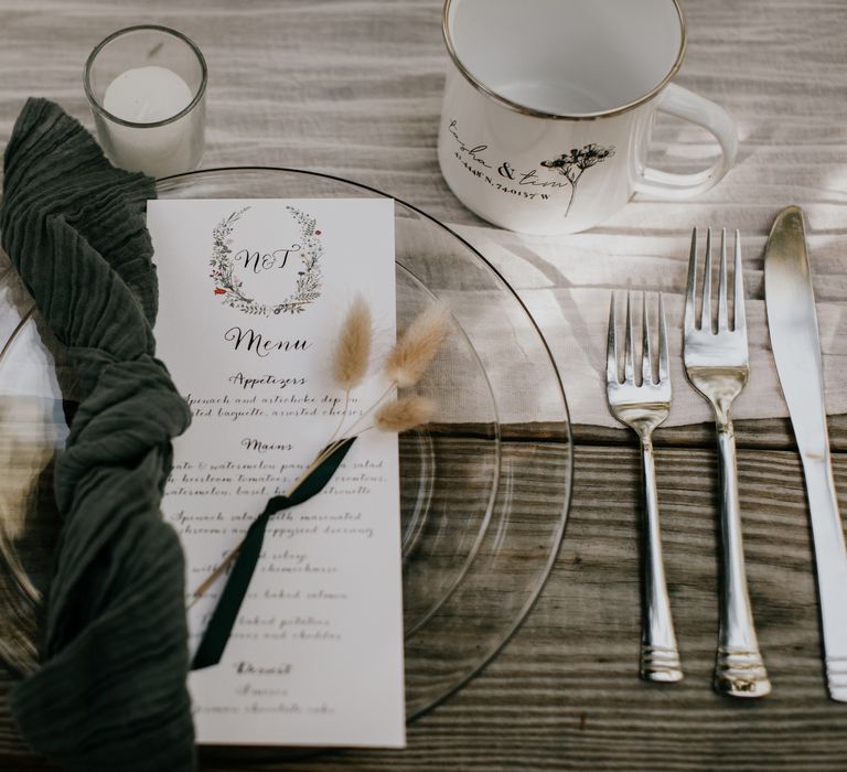 Clear plate with green napkin and menu 