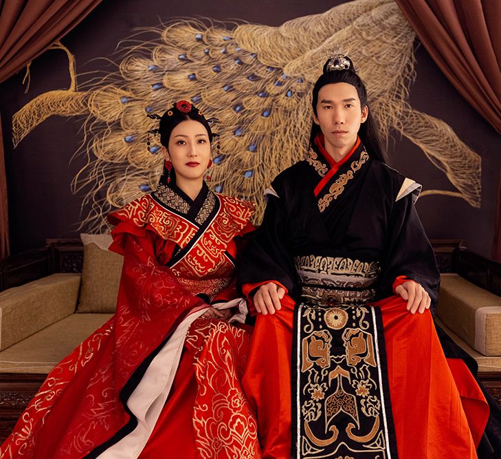 A Chinese couple pose for traditional wedding photos. 