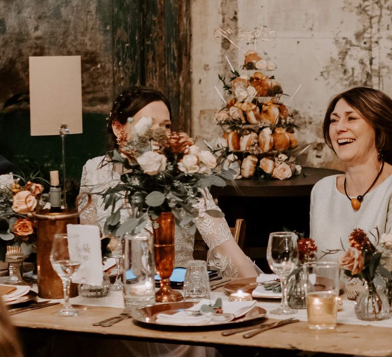 Clapton Country Club festive wedding with peach and white theme, bride and mother of the bride laughing 