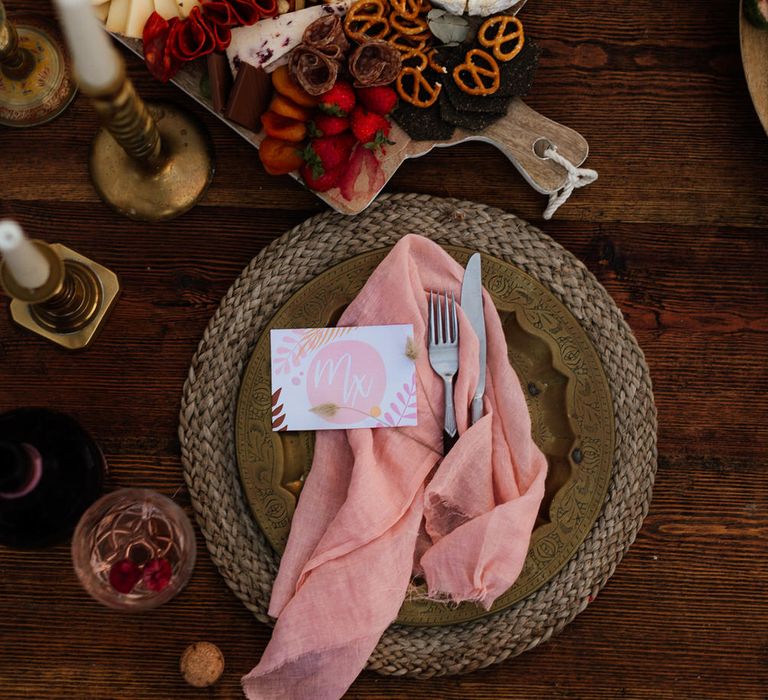 Flatlay of grazing table and place setting at beach boho elopement