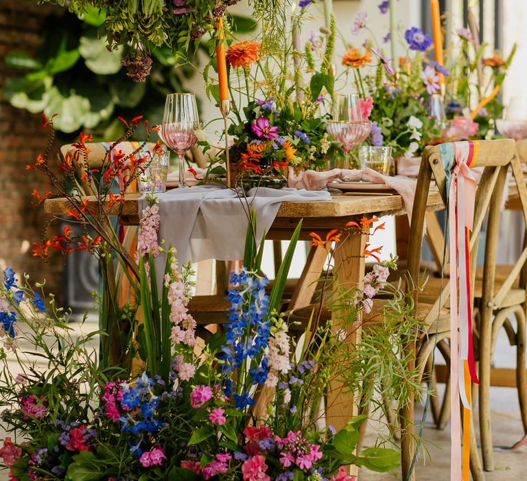 Colourful wildflower wedding decoration with installations, table end flowers and centrepieces 