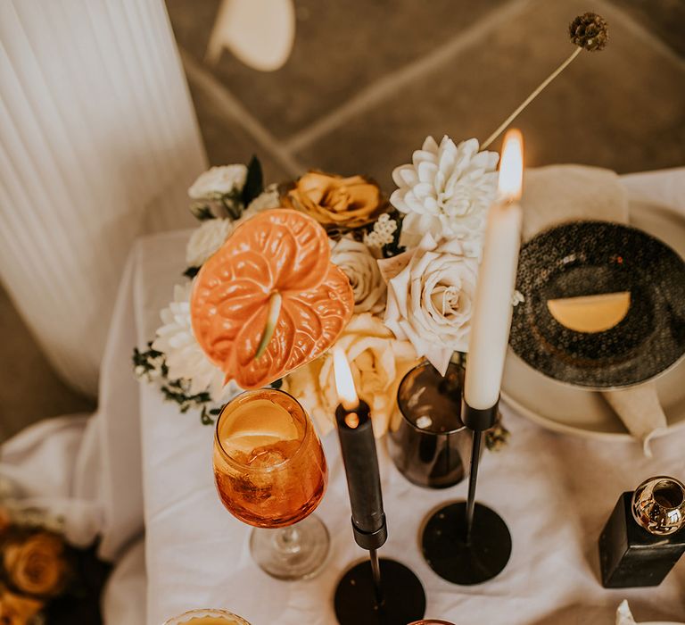 Orange wedding cocktails and a bowl full of grapes for an intimate wedding reception 