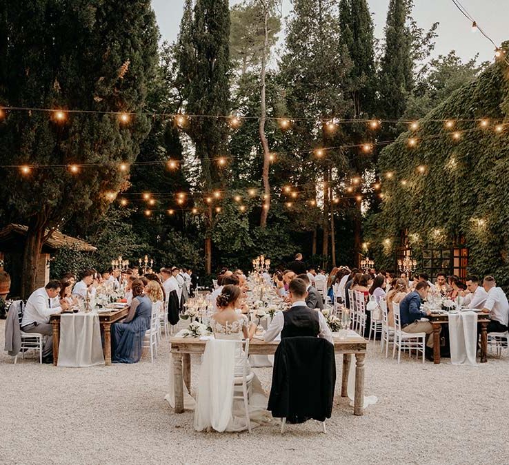 Bride & groom sit at the head of wedding reception for outdoor wedding in Italy  | Royal Studio