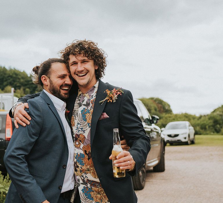 Groom poses with friend on wedding day