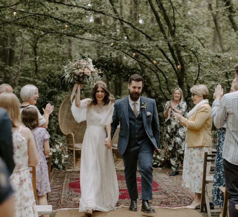 Bride & groom walk together through the woodland after wedding ceremony at The Dreys 