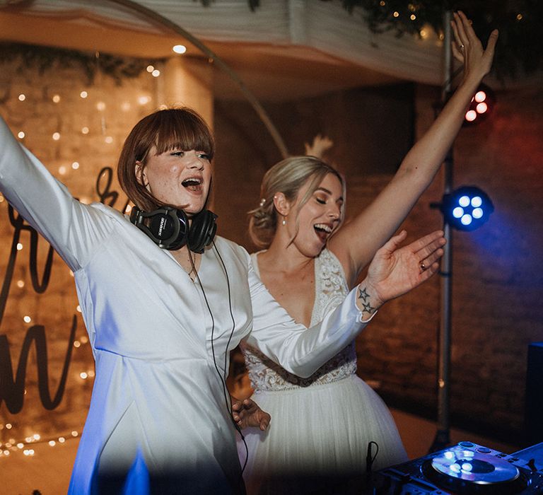 Brides celebrate as they DJ at they wedding