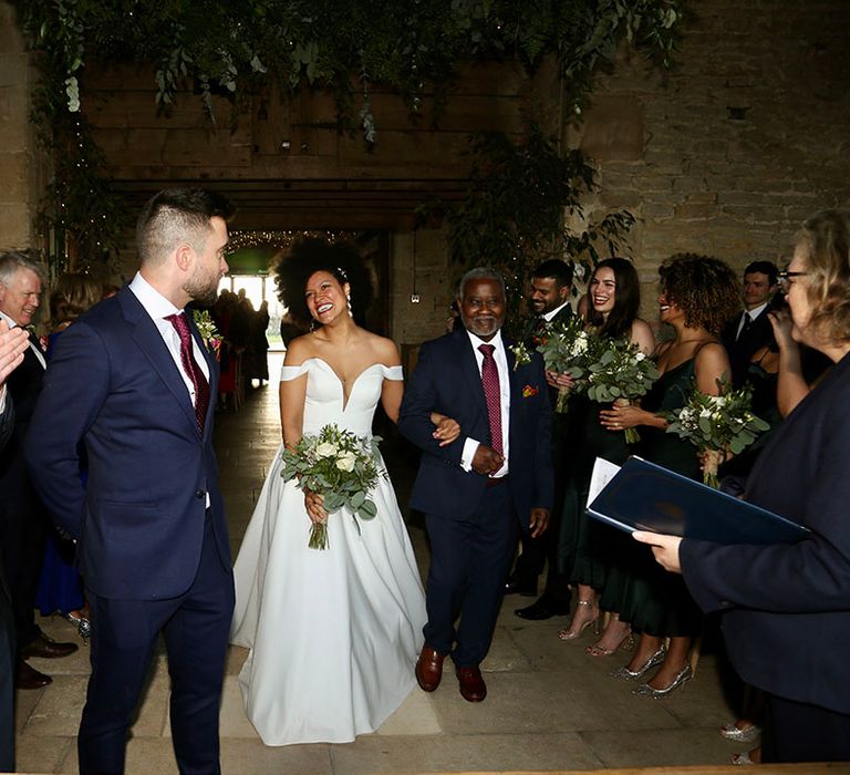 Bride walks down the aisle on her wedding day to her groom