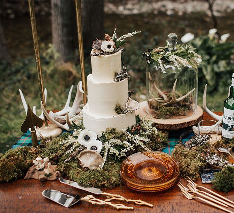 Boho wedding cake table and whisky station with buttercream wedding cake, moss, antlers and glass cloche 