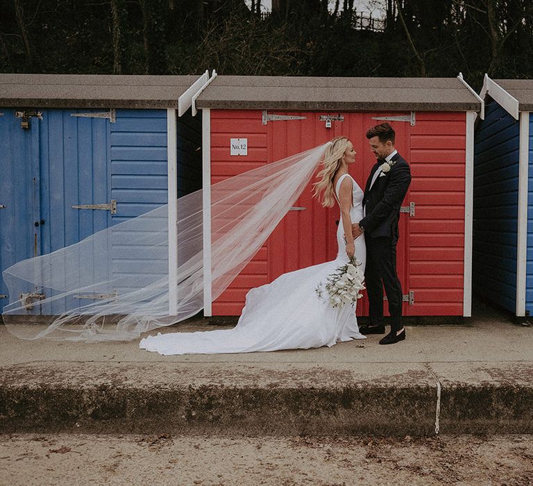 Bride and groom at beach hut wedding 