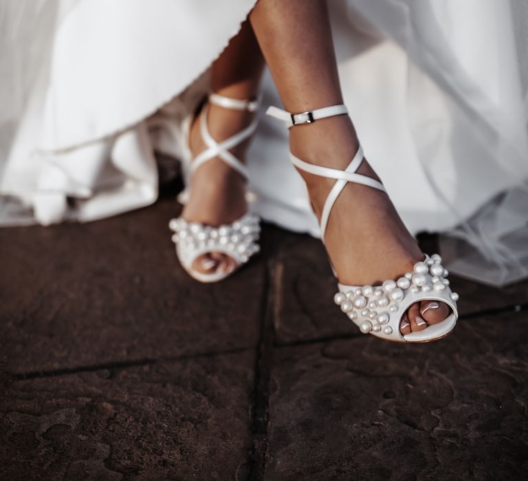 Bride with pearl peep toe wedding shoes and French manicured toe nails