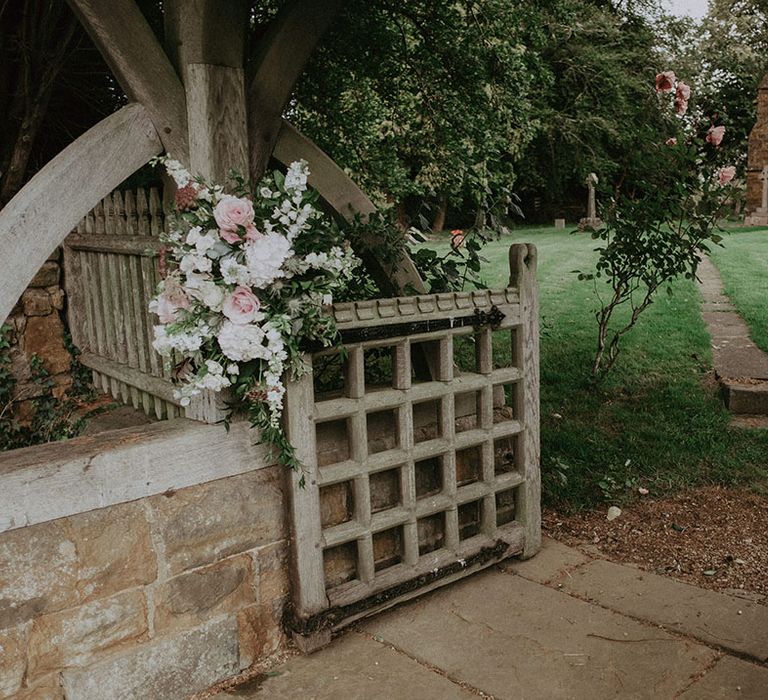 Traditional church wedding venue with pink, white and green large flower displays for wedding decor