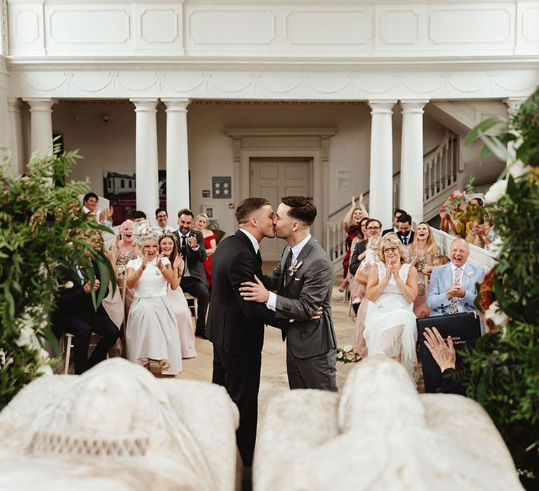 Grooms share their first kiss as a married couple at Compton Verney Art Gallery and Park 