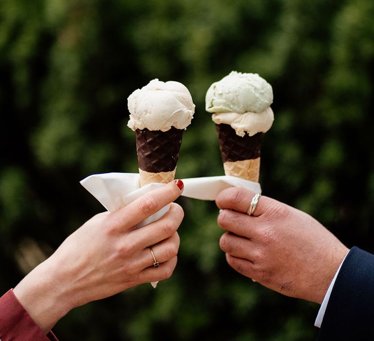 Wedding guests eat an ice cream from the ice cream van at the wedding 