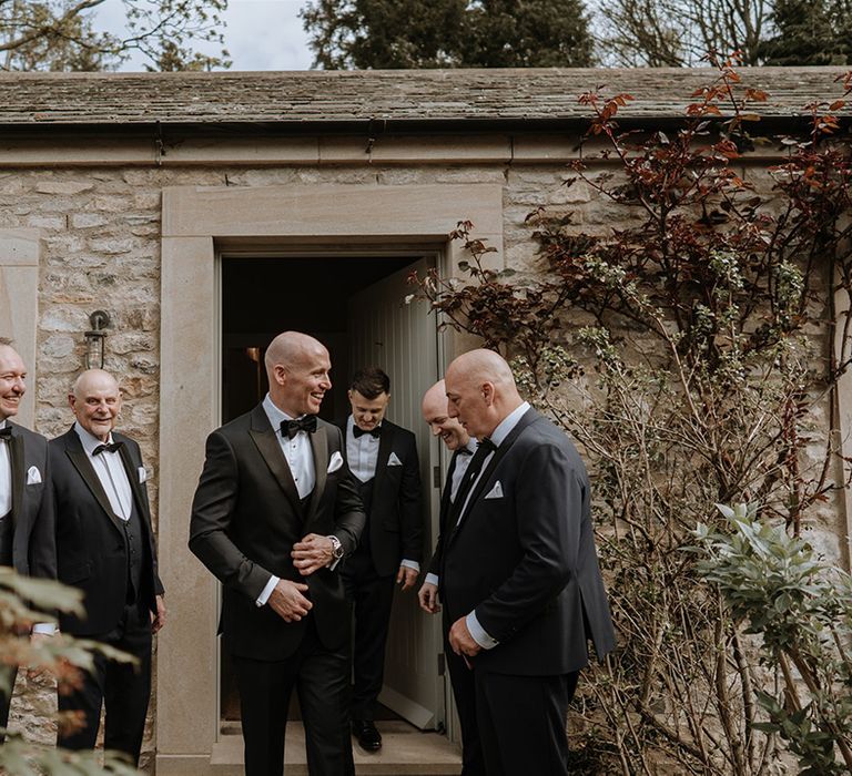 Groom with groomsmen in tuxedos for classic and traditional style wedding at Middleton Lodge 