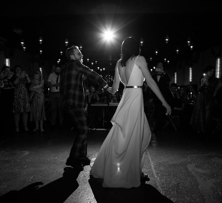 Bride & groom hold hands to dance floor on their wedding day 