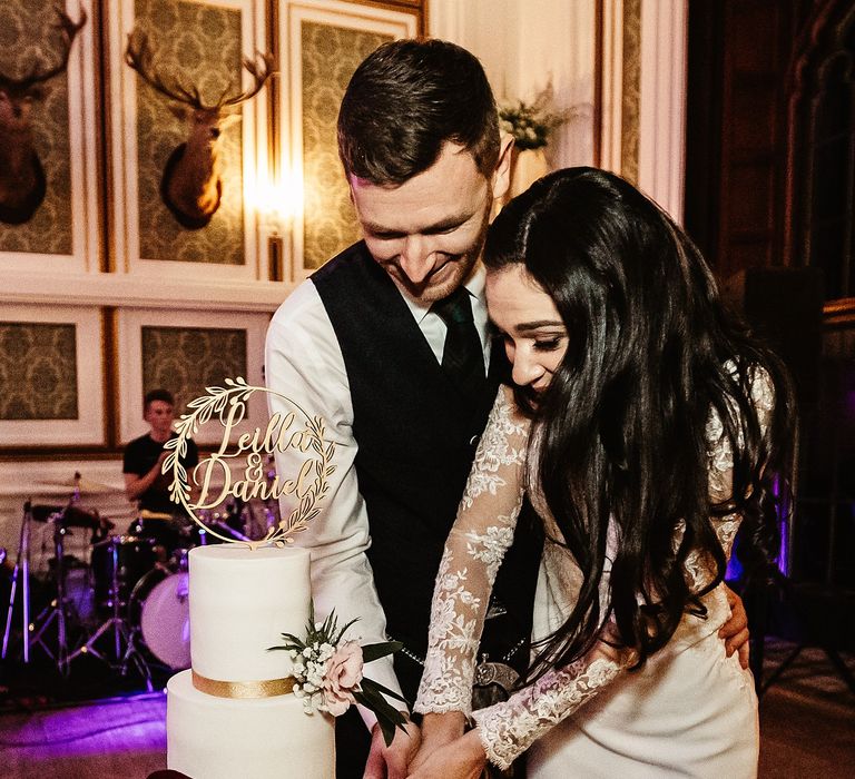 Bride & groom cut wedding cake during traditional Persian knife dance 