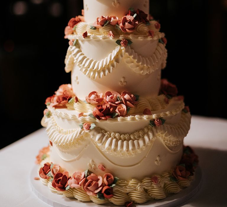 Retro styled wedding cake complete with white frosting and pink frosted roses 