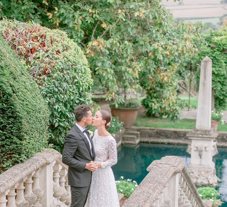 The bride and groom share a kiss on their luxe wedding day 