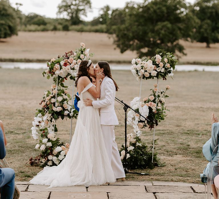 The brides share their firs kiss as a married couple at their outdoor ceremony at the Wilderness Reserve 