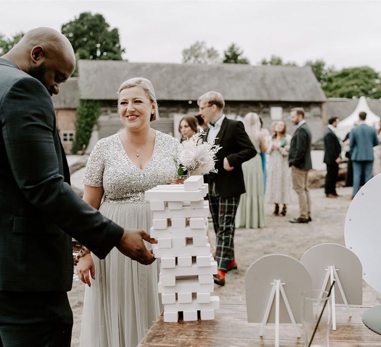 Wedding guests socialise and play the lawn games outside for fun 