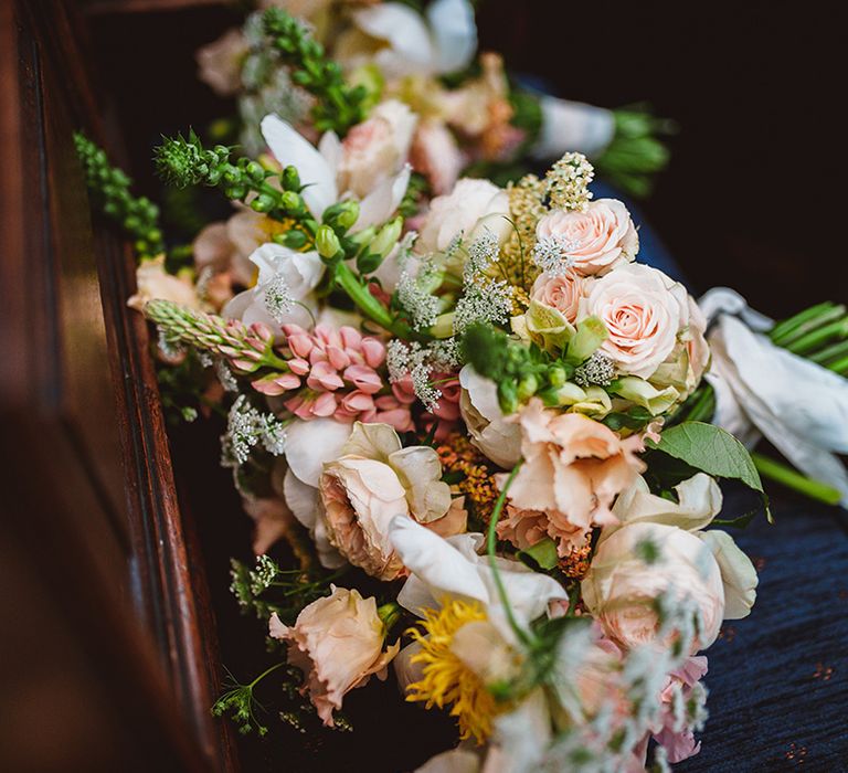 Wedding floral bouquet with pink garden roses, foliage and baby's-breath 