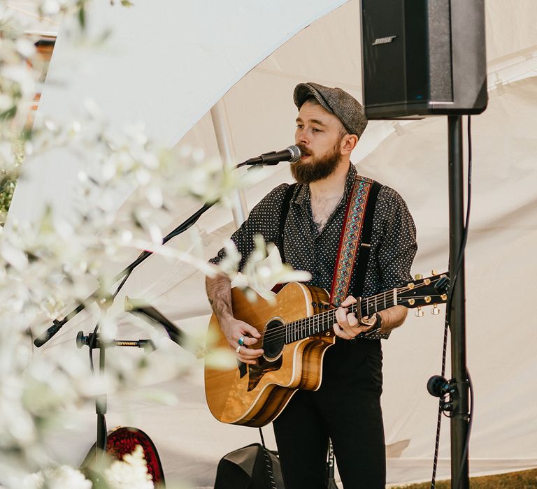 Wedding singer plays guitar during reception 