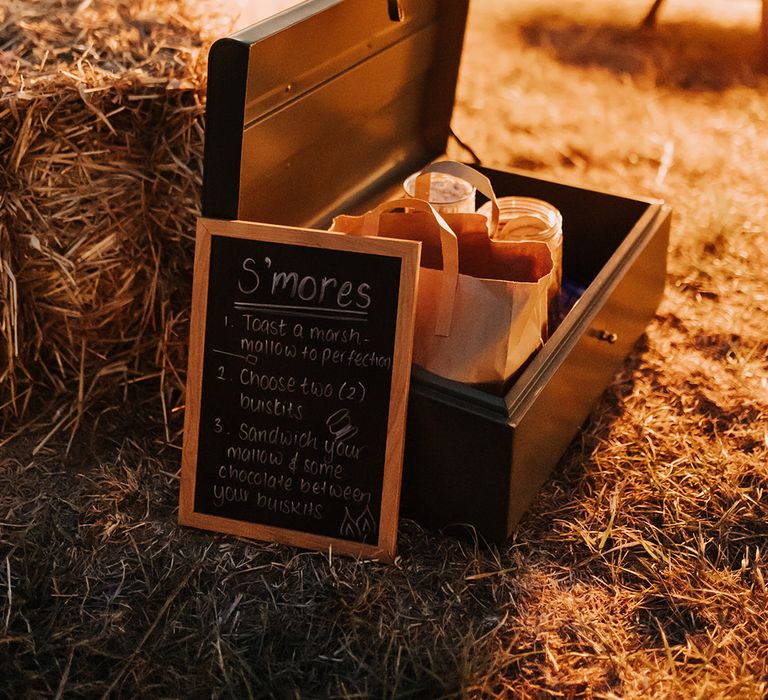 Outdoor fire pit at Duddon Mill Farm with a box full of marshmallows for a s'mores station 