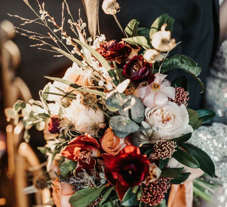 Mixed neutral bouquet with garden roses, carnations, peonies, eucalyptus, baby's-breath and dried flowers tied with mustard velvet ribbon 