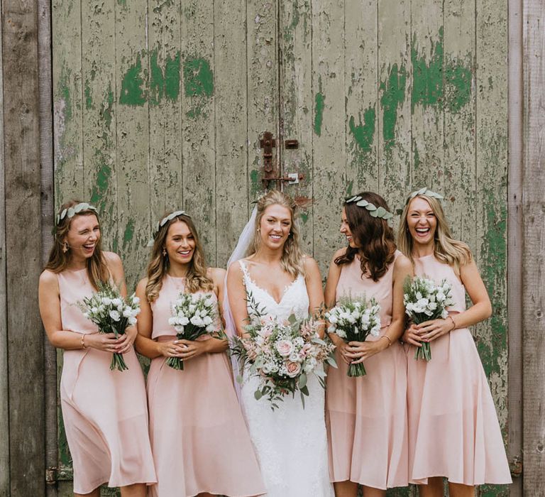 Bridesmaids in pale pink knee length bridesmaid dresses