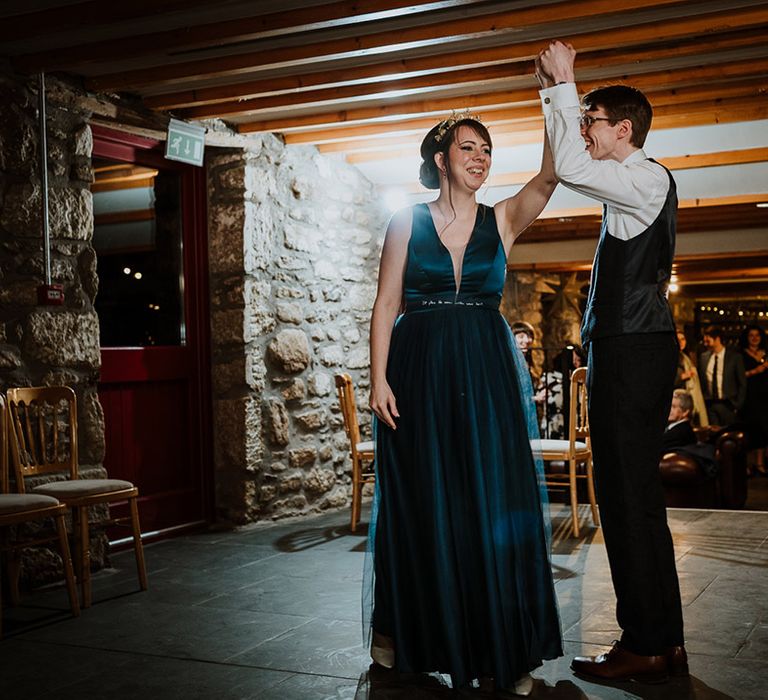 Bride in blue satin wedding reception dress having her first dance with the groom on their wedding day 