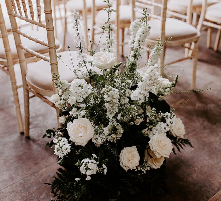 White wedding aisle meadow flowers for classic wedding at barn wedding venue 