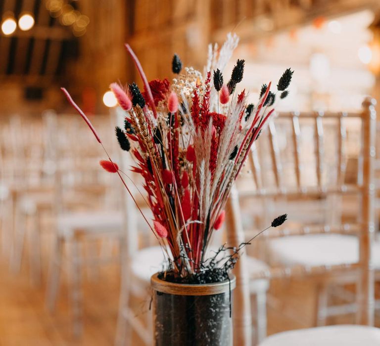 Black, red and white pampas grass aisle flower arrangements at Southlands Barn