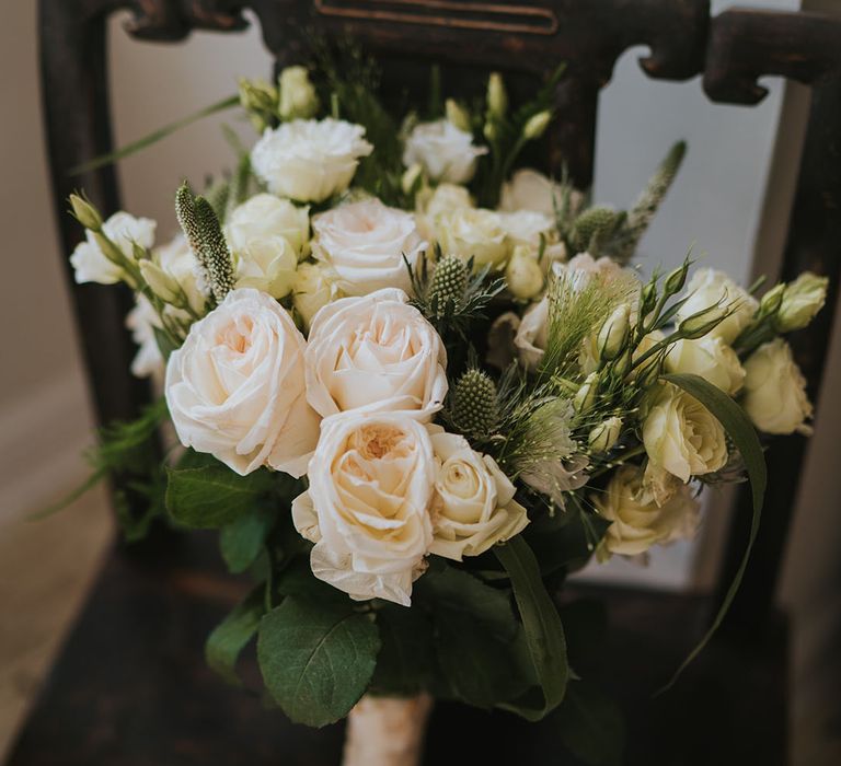 Classic and traditional wedding bouquet with white roses 