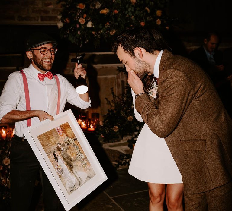 The bride and groom react to their live wedding painting keepsake