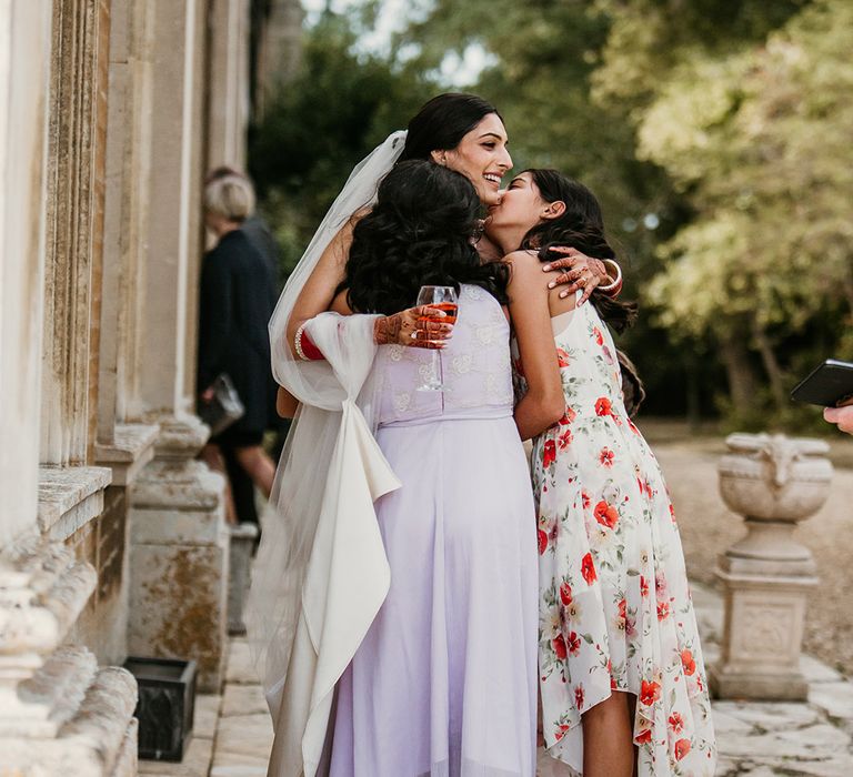 The bride embraces wedding guests at the multicultural wedding 