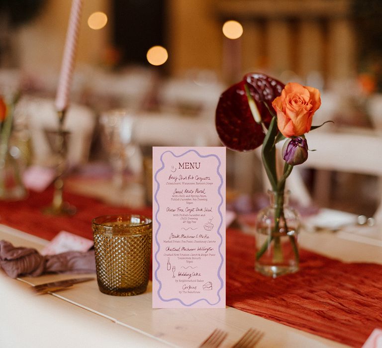 DIY pink wedding menu stationery with anthuriums and roses in bud vases