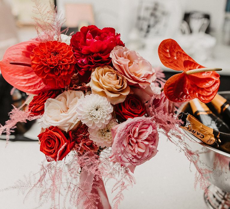 Red and pink wedding bouquet with roses and anthuriums 