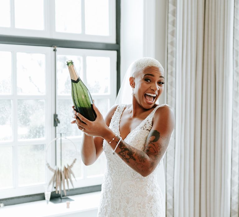 Bride pops bottle of champagne on the morning of the wedding 