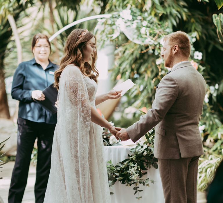 Bride reads her personalised wedding vows to the groom at their civil ceremony 