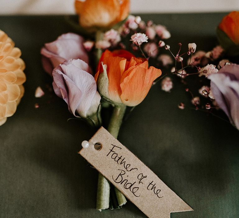 Purple and orange mini rose wedding buttonholes for the groom and groomsmen 