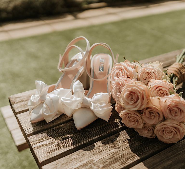 White bow wedding shoes with pink rose wedding bouquet bridal accessories 