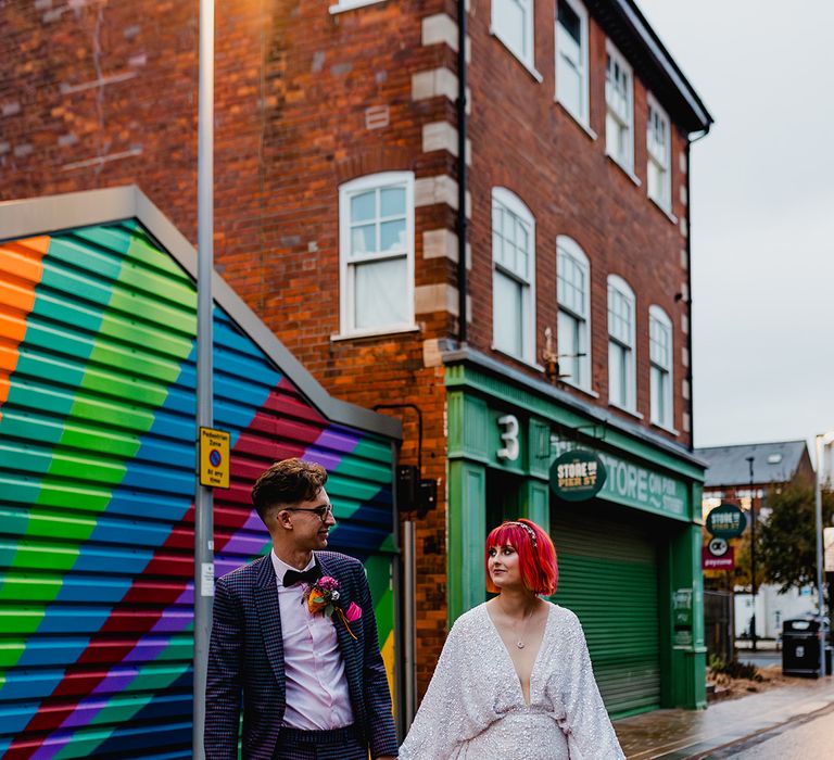 Bride wearing sequin bat wing wedding dress with groom in purple checkered suit for ASOS 