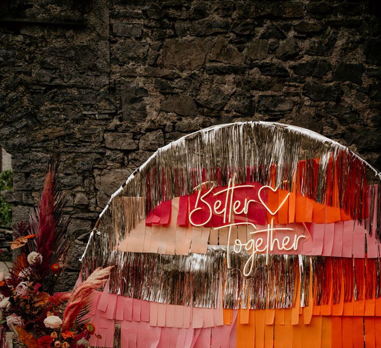 Pink, Orange & Silver Streamer Wedding Altar Decor with Neon Sign