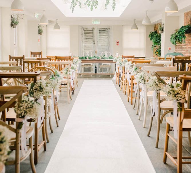 Aisle and altar at Kedleston Country House with white and green flowers