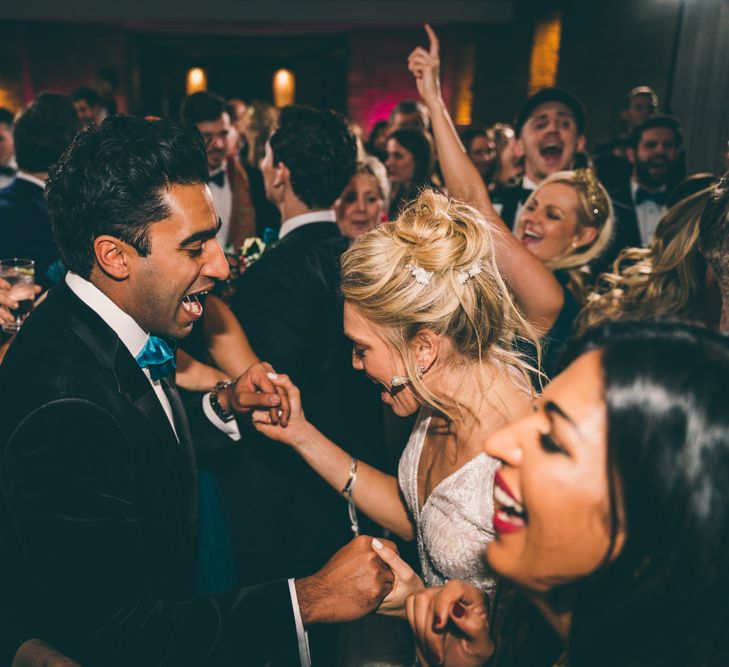 Bride and groom dancing at festive wedding 