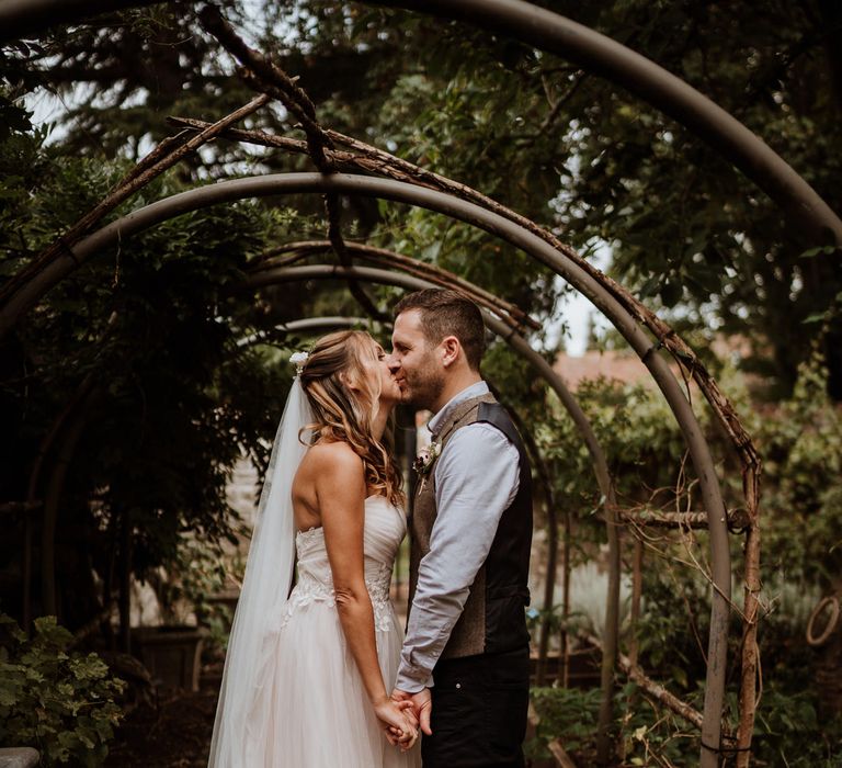 Bride in blush strapless wedding dress and cathedral length veil 